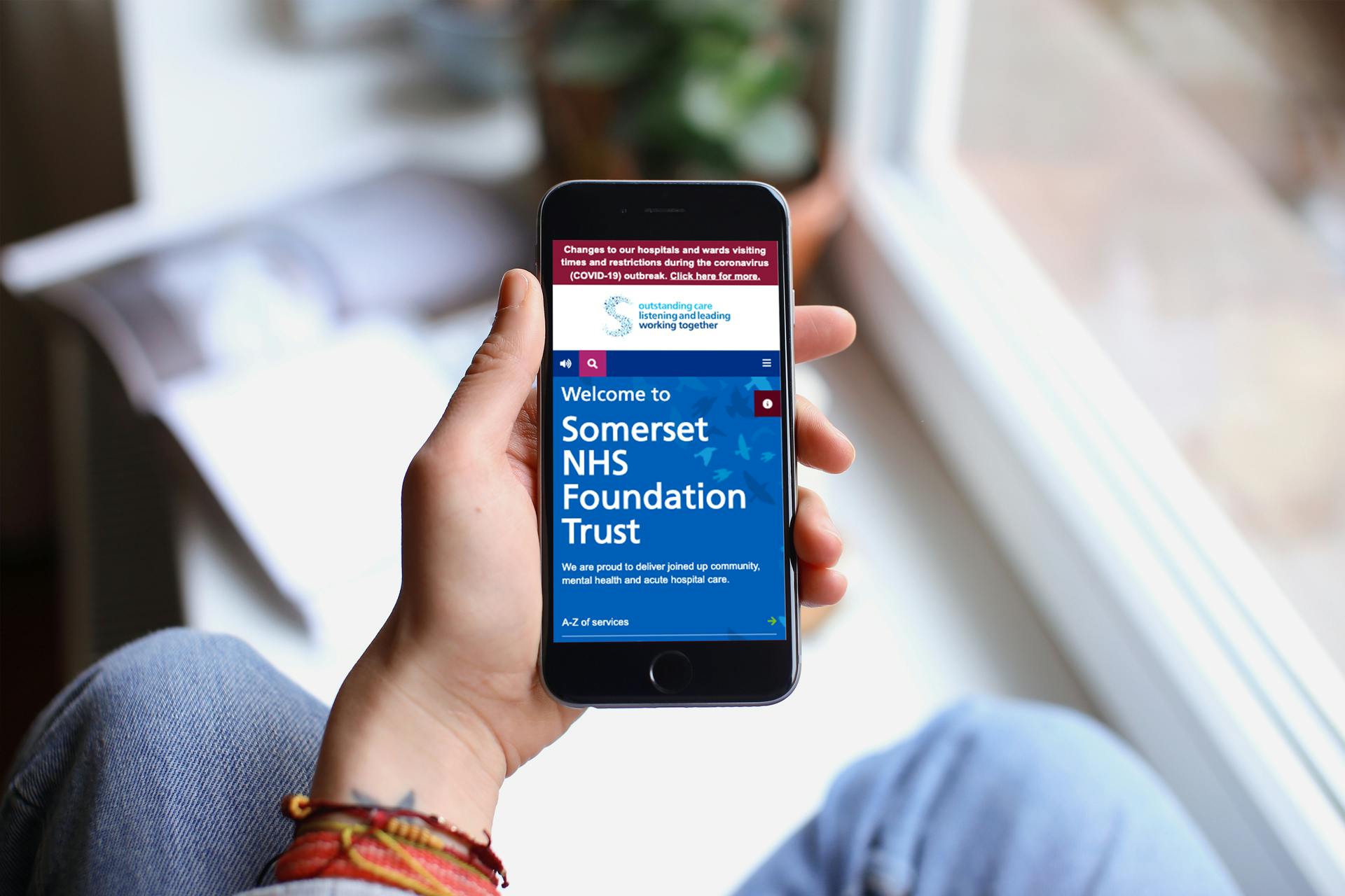 Person visiting NHS Trust site on smartphone